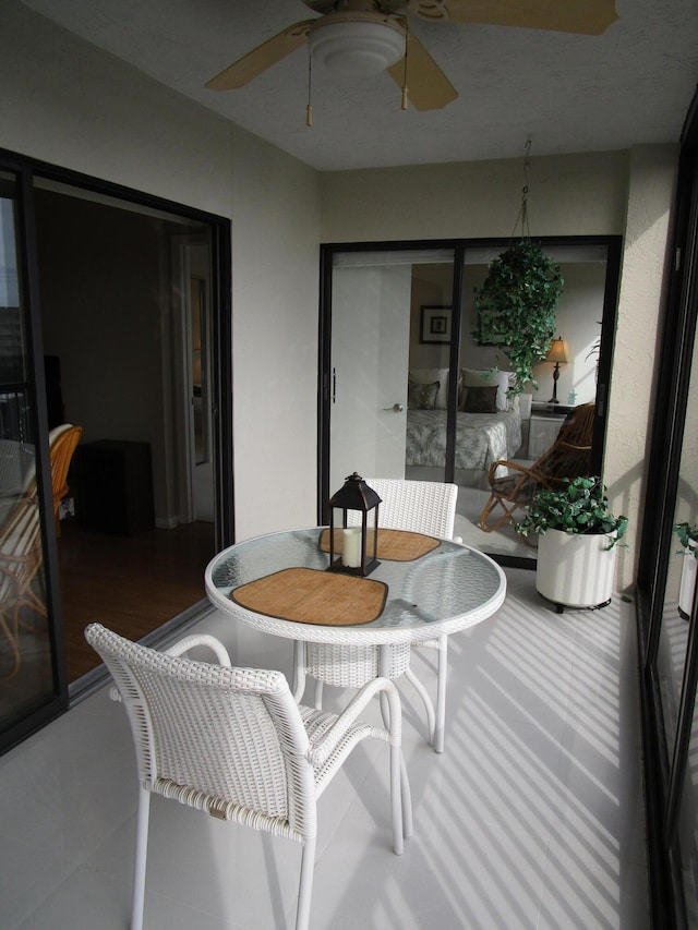 sunroom / solarium featuring ceiling fan