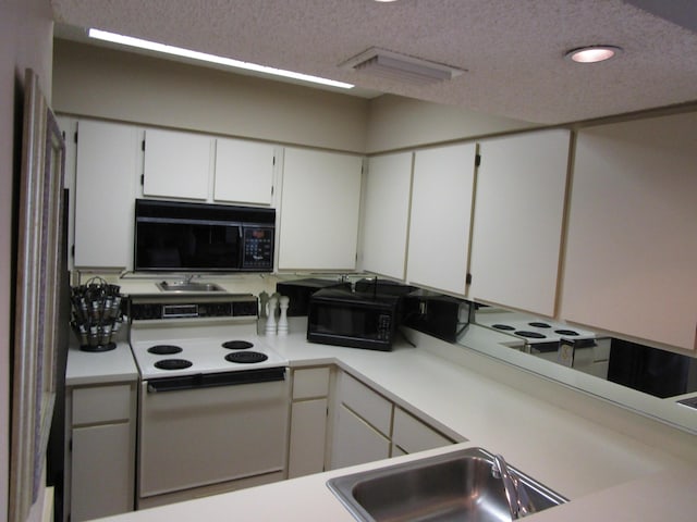 kitchen featuring white cabinetry, sink, a textured ceiling, and electric range