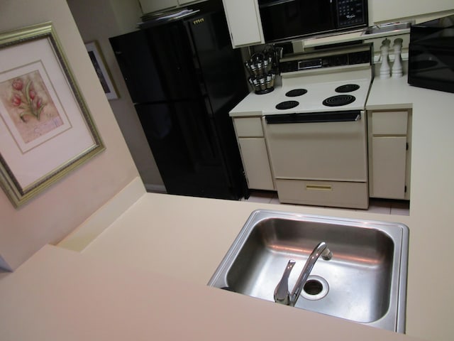 kitchen with sink and black appliances