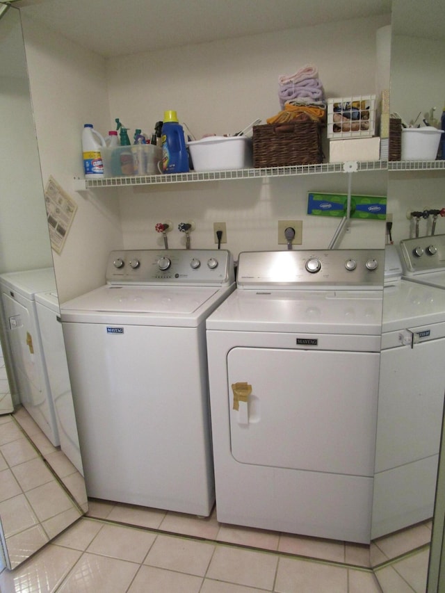 laundry area with light tile patterned floors and independent washer and dryer