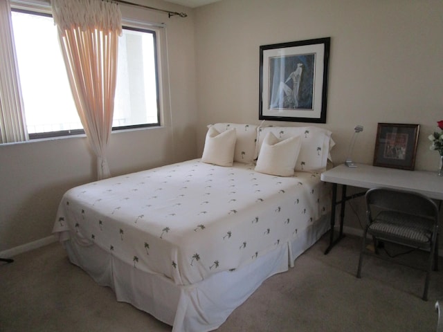 carpeted bedroom featuring multiple windows