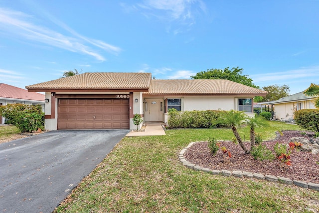 ranch-style house featuring an attached garage, a tile roof, driveway, stucco siding, and a front lawn