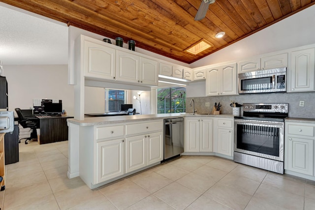 kitchen featuring light tile patterned floors, a sink, wood ceiling, appliances with stainless steel finishes, and tasteful backsplash