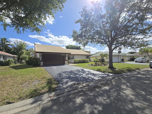 view of front of property featuring a garage and a front yard