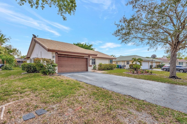 single story home featuring stucco siding, an attached garage, driveway, a tiled roof, and a front lawn