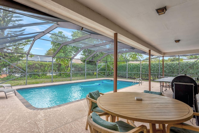 outdoor pool with glass enclosure, outdoor dining area, and a patio