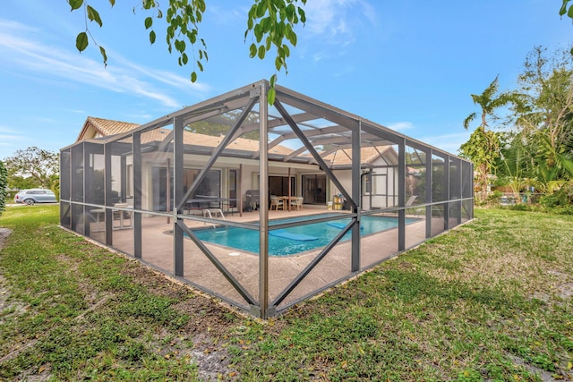 pool with a lawn, a lanai, and a patio area