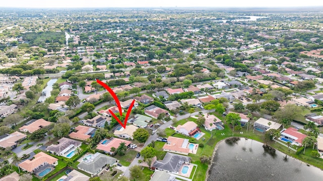 bird's eye view featuring a residential view and a water view