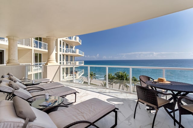 balcony featuring a water view and a view of the beach