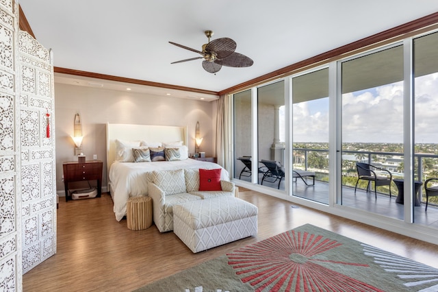 bedroom featuring access to exterior, hardwood / wood-style floors, floor to ceiling windows, and ceiling fan