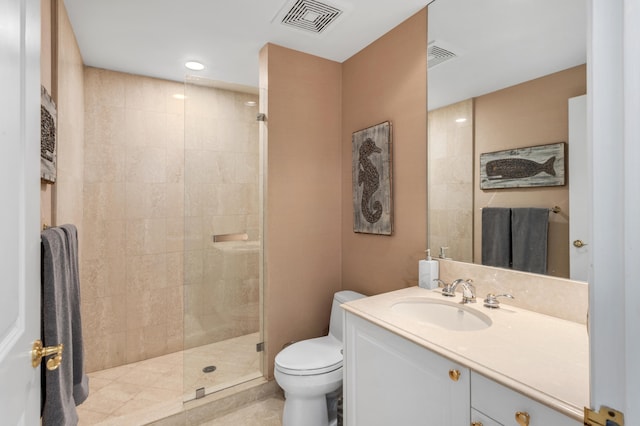 bathroom featuring vanity, tiled shower, and toilet