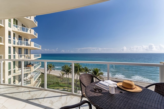 balcony featuring a water view and a beach view