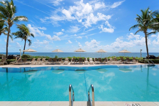 view of swimming pool featuring a water view