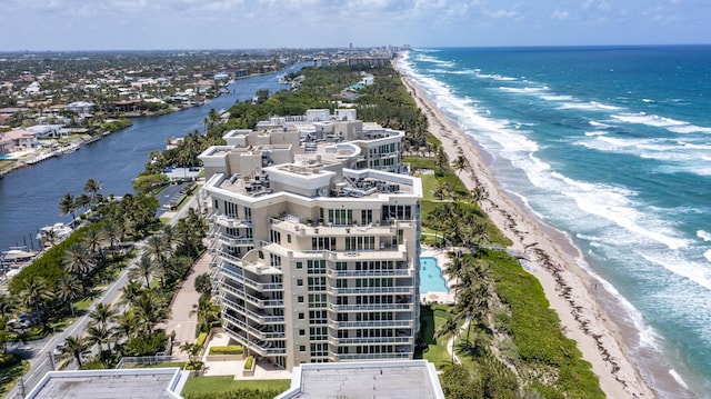 drone / aerial view featuring a water view and a view of the beach