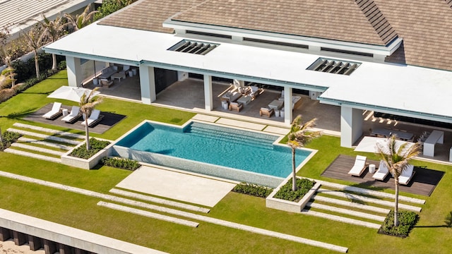 1160 S Ocean Blvd, Manalapan, FL 33462 - rear view of property with a patio area, a yard, an outdoor pool, and outdoor lounge area