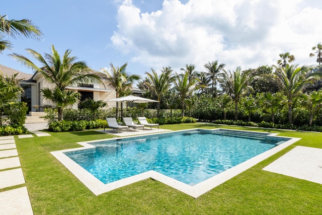 view of pool featuring a patio and a lawn