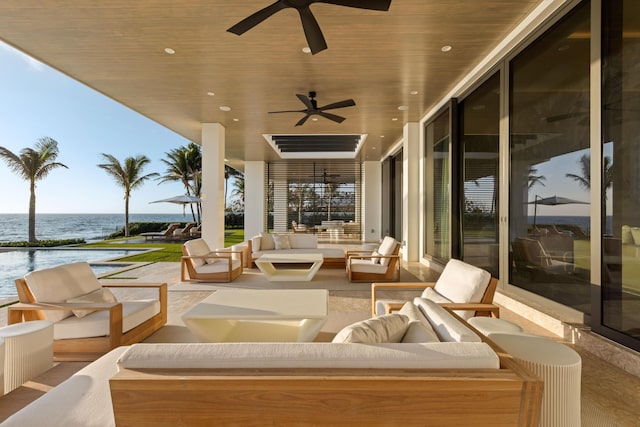 view of patio / terrace featuring a water view, an outdoor hangout area, and ceiling fan