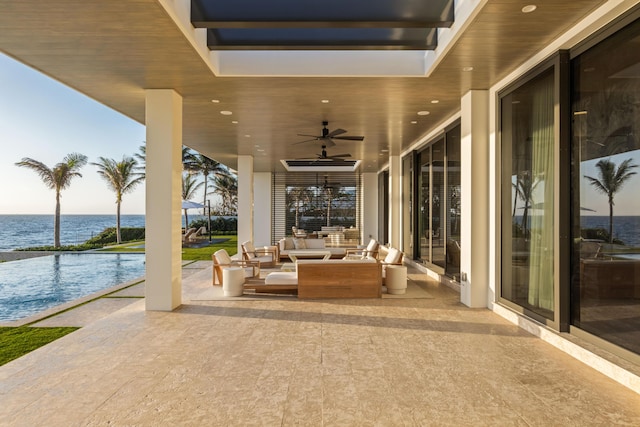 1160 S Ocean Blvd, Manalapan, FL 33462 - view of patio with an outdoor living space, a water view, and a ceiling fan