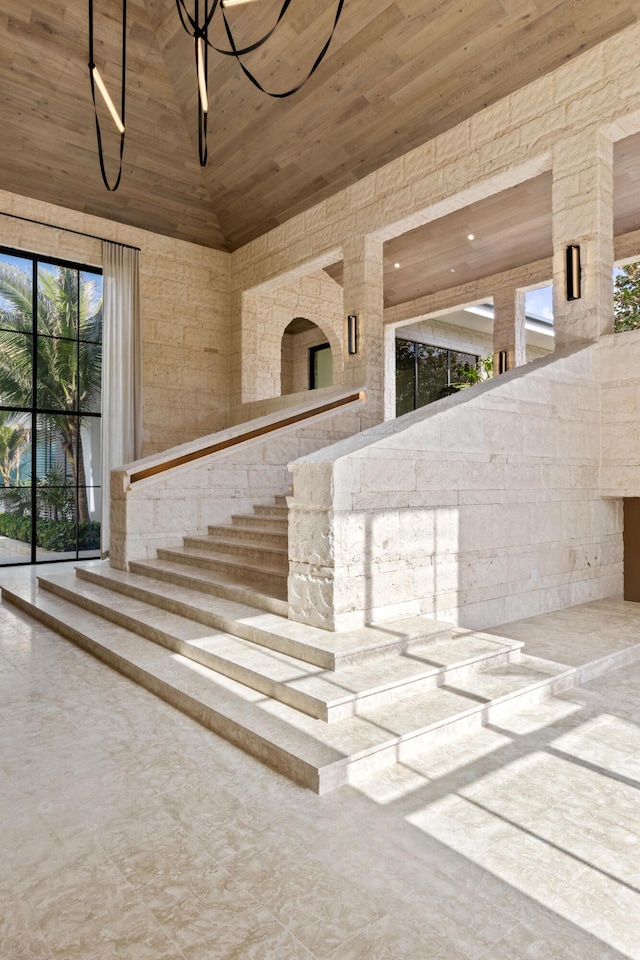 doorway to property with high vaulted ceiling and wood ceiling