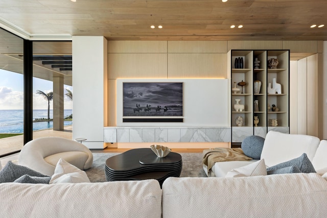 living room featuring hardwood / wood-style flooring, a water view, wood ceiling, and floor to ceiling windows