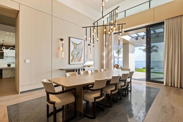 dining room featuring a water view and wood-type flooring