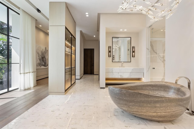 1160 S Ocean Blvd, Manalapan, FL 33462 - hall with a chandelier, baseboard heating, and recessed lighting