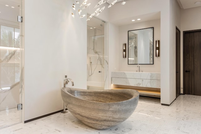 bathroom with a shower with shower door and vanity