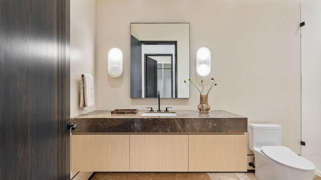 bathroom featuring toilet and vanity