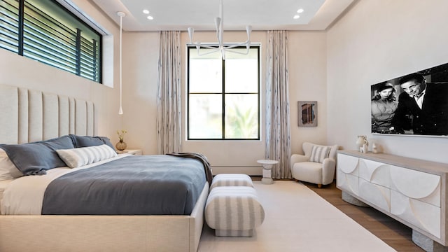 bedroom featuring multiple windows and hardwood / wood-style flooring