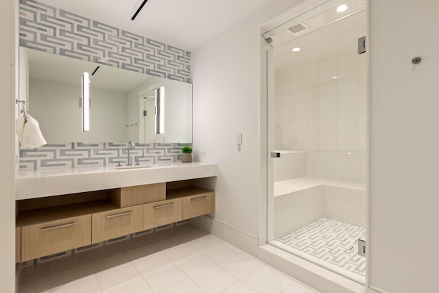 bathroom featuring tile patterned flooring, vanity, and walk in shower