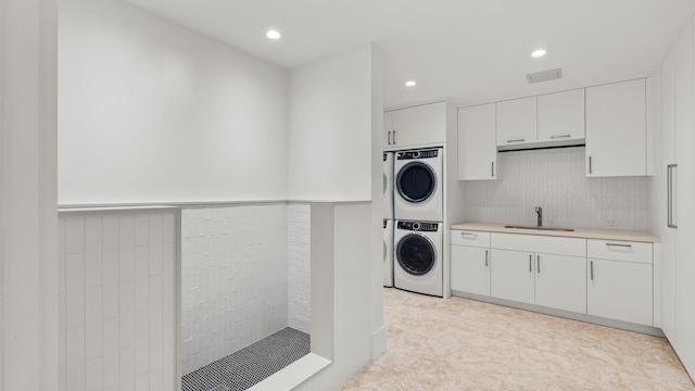 washroom featuring sink and stacked washer and dryer