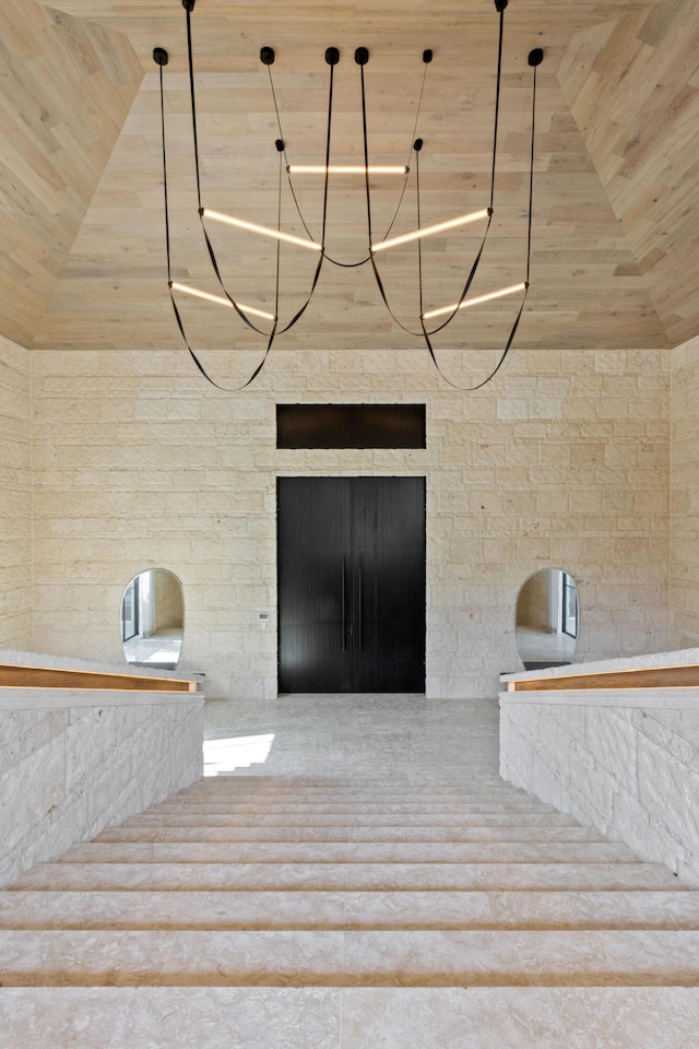 stairway with vaulted ceiling and wooden ceiling