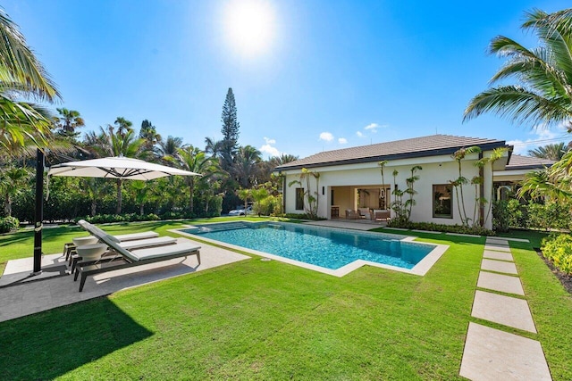 view of pool with a lawn and a patio area