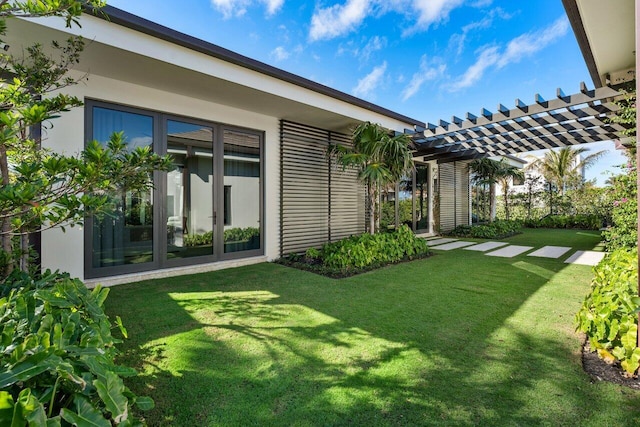 view of yard with french doors and a pergola