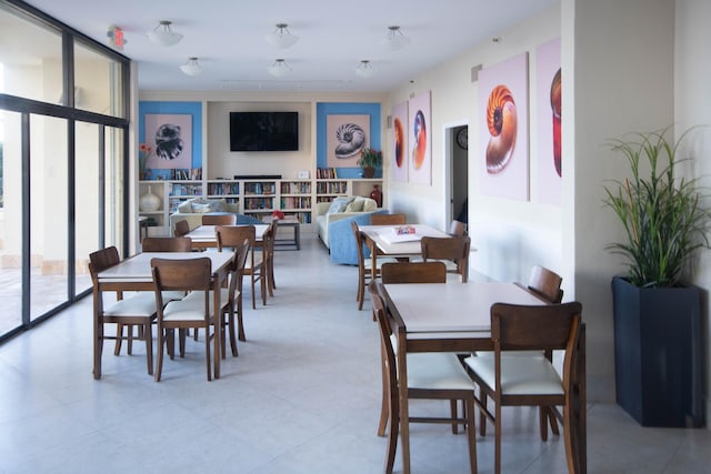 dining area with crown molding and a wall of windows