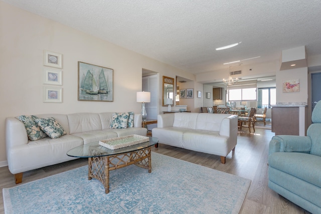 living room with hardwood / wood-style flooring and a textured ceiling