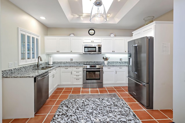 kitchen featuring sink, stainless steel appliances, light stone countertops, white cabinets, and tile patterned floors