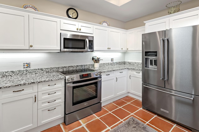 kitchen featuring tasteful backsplash, white cabinetry, and appliances with stainless steel finishes