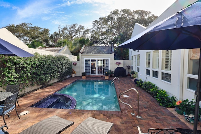 view of swimming pool with an outbuilding and a patio area