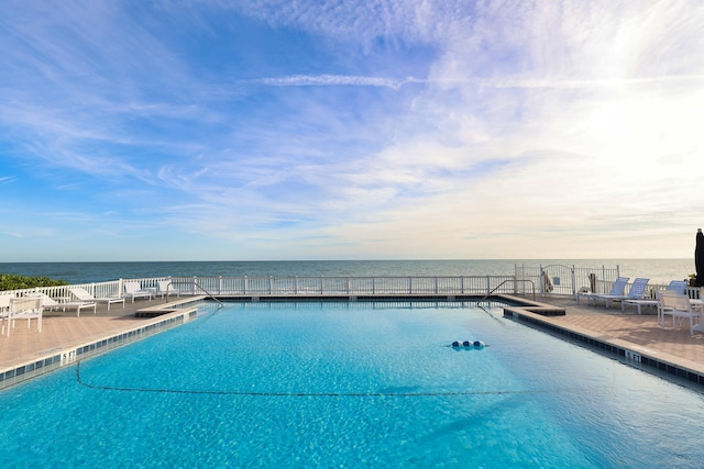 view of pool with a water view