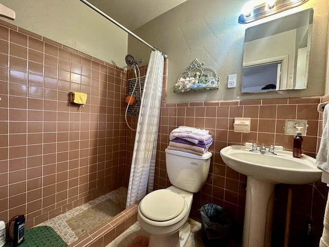 bathroom with a shower with curtain, toilet, and tile walls