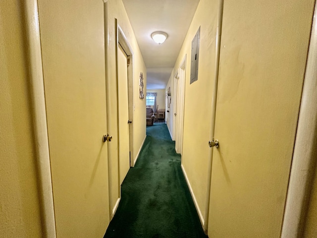 hall with dark colored carpet