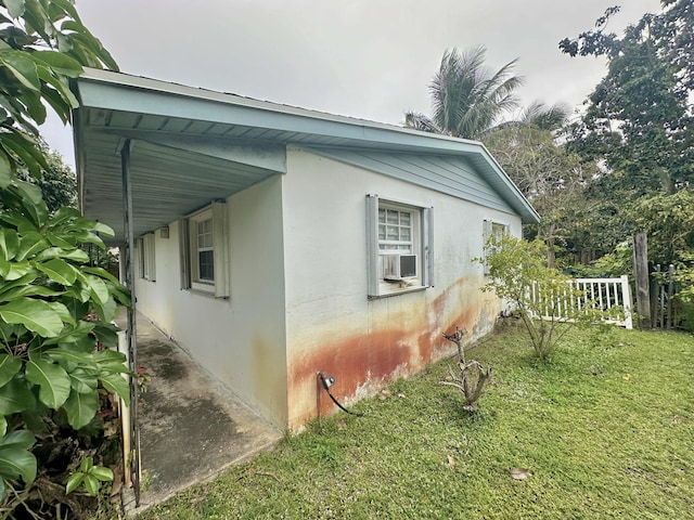 view of side of property with a lawn