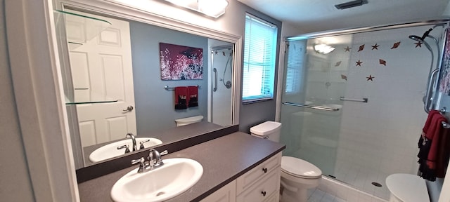 bathroom featuring vanity, plenty of natural light, toilet, and walk in shower