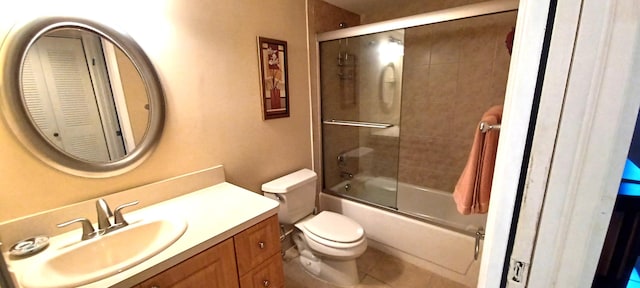 full bathroom with enclosed tub / shower combo, vanity, toilet, and tile patterned floors