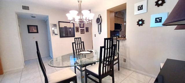 tiled dining room featuring a notable chandelier