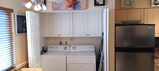 washroom featuring separate washer and dryer and cabinets