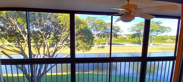 room details featuring a water view and ceiling fan