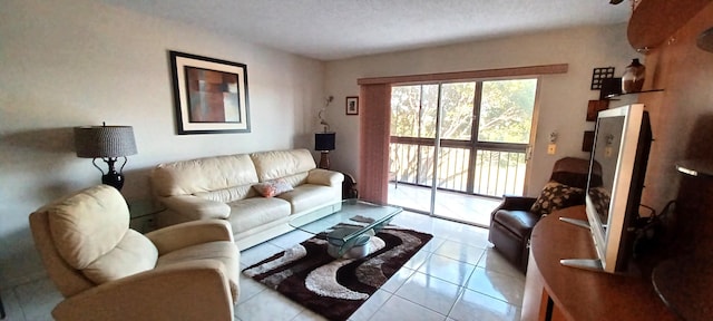 tiled living room featuring a textured ceiling