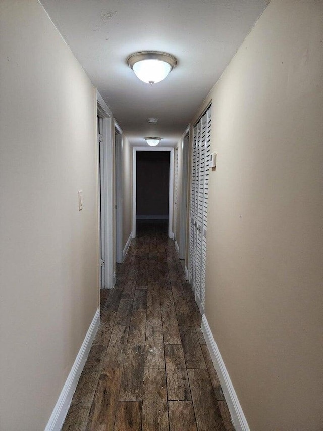 corridor with dark wood-type flooring